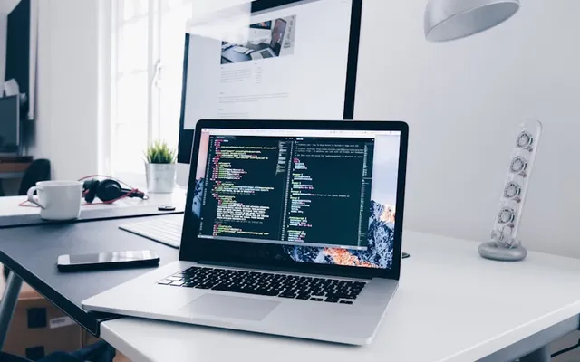 Engineers at laptops with dashboards suggesting metrics and control